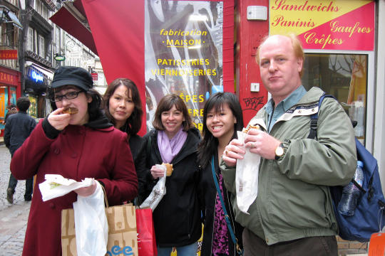 Sandwich shop on street with big clock in Rouen